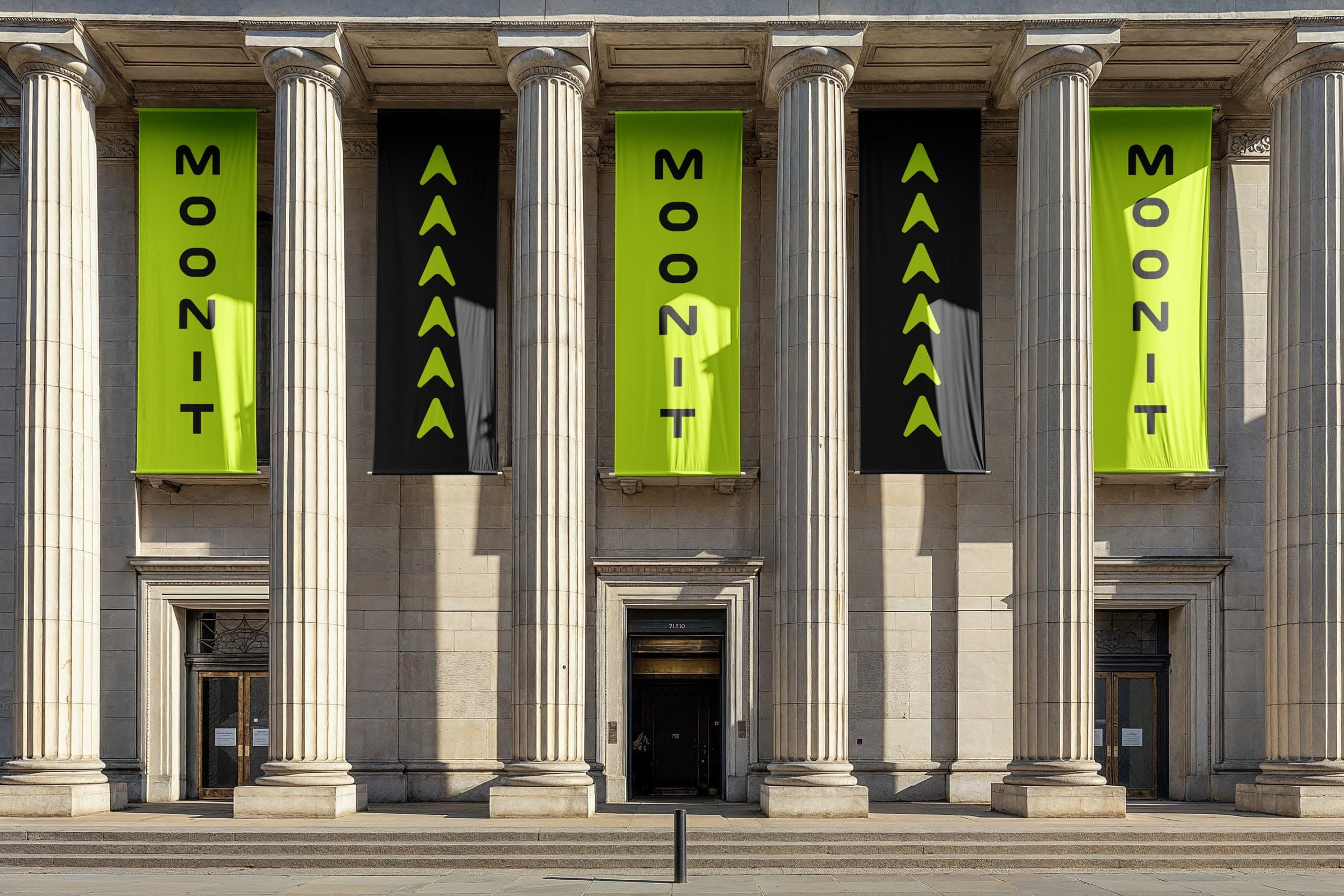 Moonit banners hung between the columns of a classical stone building